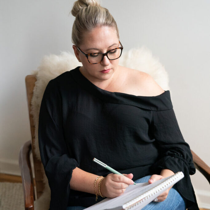 Richelle writing in a notebook